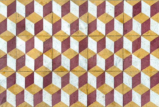 Close up of random cut marble floor tiles pattern in 3D cube and hexagonal pattern. 3D Geometrical floor pattern in red, beige, and white color. Seamless background texture