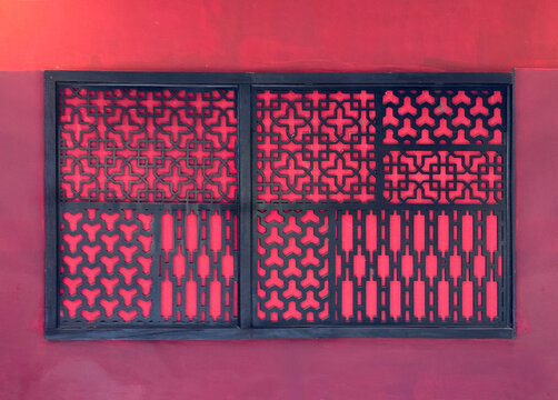 Random round ornamental decorative ethnic floral pattern. 3D laser cutting panels in black paint at red wall background. Seamless background texture.