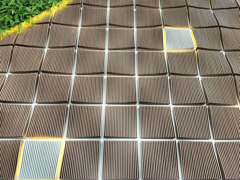 Close up of parametric fluted panel with curves and repetitive lines, made of brown wood. Suitable for interior design decoration. Parametric concept. Seamless background texture.