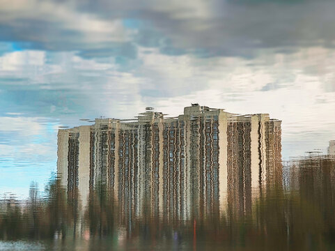 Dramatic abstract building reflected on spring lake landscape