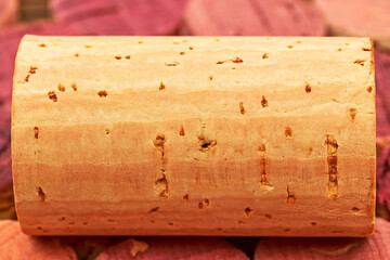 Fototapeta premium Cork resting on a pile of colored cork slices in a natural setting during daylight hours