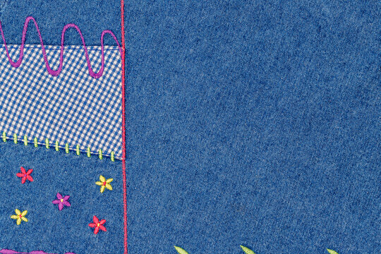 Colorful fabric patchwork with embroidery and stitched patterns in a sewing project