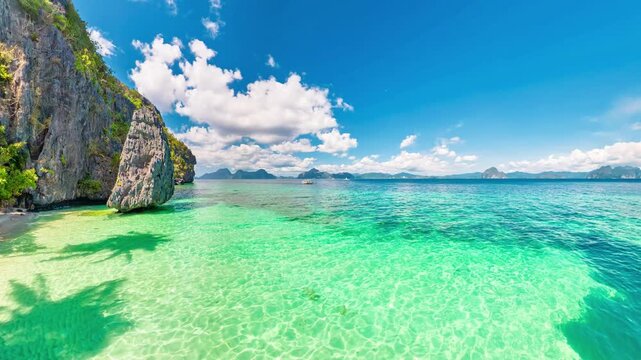 360 view of Entalula Beach lagoon with crystal turquoise water framed by towering limestone cliffs and swaying palms, idyllic Palawan escape for island hopping and relaxation in El Nido, Philippines