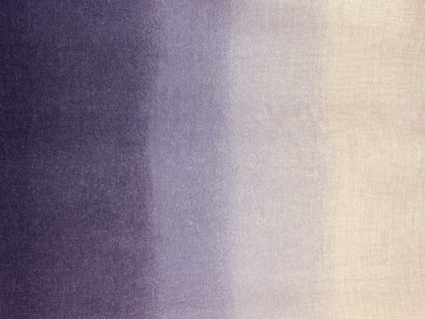 Close up of linen fabric or canvas finished in gradient purple and white color. Suitable for fabric, canvas, upholstery, or wallpaper. Seamless background texture.