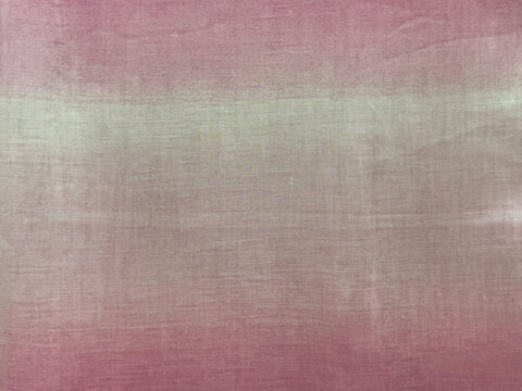 Close up of linen fabric or canvas finished in gradient pink and white color. Suitable for fabric, canvas, upholstery, or wallpaper. Seamless background texture.