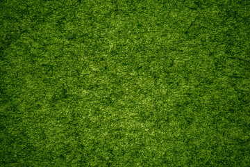 Fototapeta premium Bright green textured surface shows fibers and threads in a close-up view