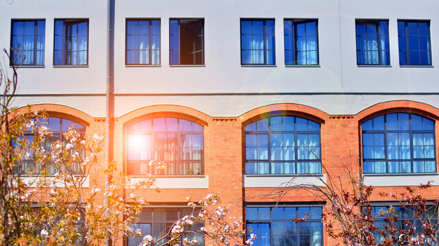 European residential architecture harmonizing with nature. Eco-friendly living in city with greens. Eco apartment building saving energy and fresh air concept. 