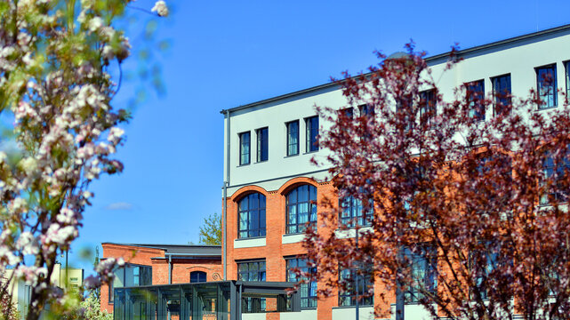 European residential architecture harmonizing with nature. Eco-friendly living in city with greens. Eco apartment building saving energy and fresh air concept. 