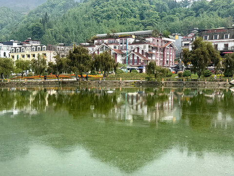 Sapa lake in the morning with its clear water and willow trees, reflecting the buildings and mountains at its background. Fresh ambience. A major landmark spot.