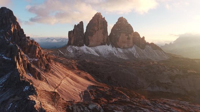 Alpine landscape of Tre Cime mountain peak with mountain hut during autumn in Dolomites, Italy