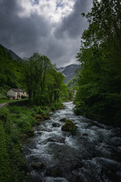 mountain river with dramatic cloudy sky. Ariege Pyrenees France
