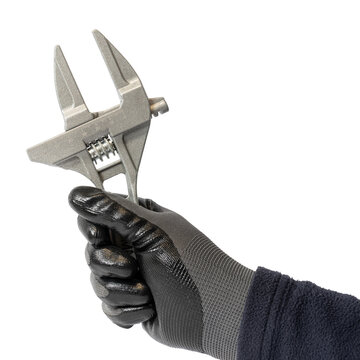 Human hand in work glove holding an adjustable wrench cut out