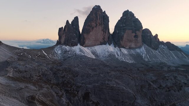 Alpine landscape of Tre Cime mountain peak with mountain hut during autumn in Dolomites, Italy