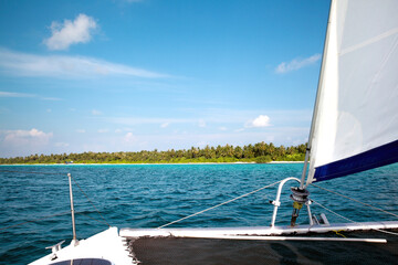 Sailing Yacht Approaching Tropical Island Beach Paradise © VuVan