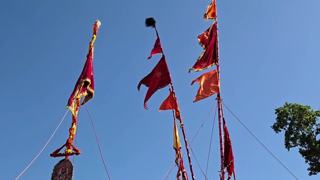 Vibrant Sasan Kathi poles with flags and Jyotiba&rsquo;s photo at the Kolhapur festival. These symbols of victory over evil are carried by devotees during the Chaitra Yatra and rural Chhabina celebrations.