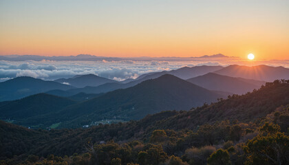 Obraz premium Sunset over mountain range with trees and foggy valleys below 1 (273).png