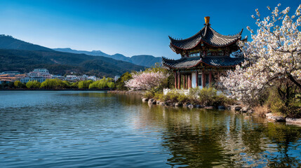 Fototapeta premium Visitors enjoy a sunny day by the lake in an Asian city. Cherry blossom trees frame the scene, with a traditional building reflecting on the water