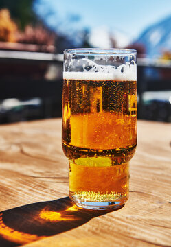 Pale lager in a classic pint glass outdoors 