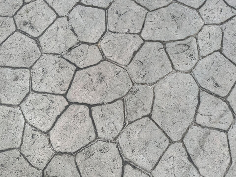 Natural random cut grey flagstone flattened on a surface. Or a series of cobble stones but flattened and paved seamlessly, for floor or wall finishes.      