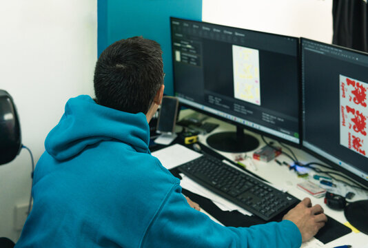 Person working on computer with dual monitors