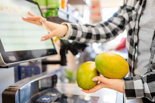 Girl Scanning At Self-Checkout