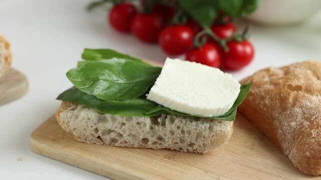 Woman hands cooking healthy panini sandwich with lettuce, mozzarella cheese and tomatoes. Italian style panini sandwich