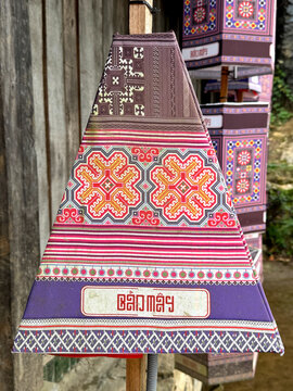 Graphic background of traditional ethnic pattern in various geometric shapes with flower, lace, diamond, and other ornamental shapes, in various purple, blue, pink, and red colors.