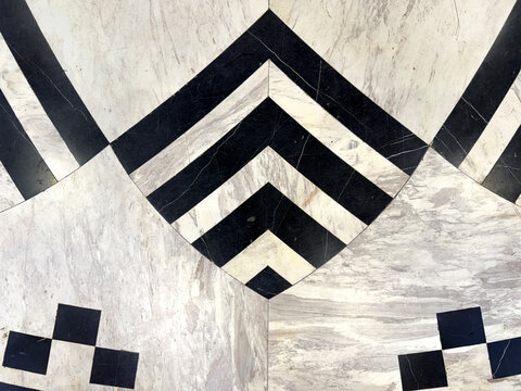 Graphic background of black and white marble carved and cut in curved lobe with stripes pattern. For wall and flooring. seamless background texture.