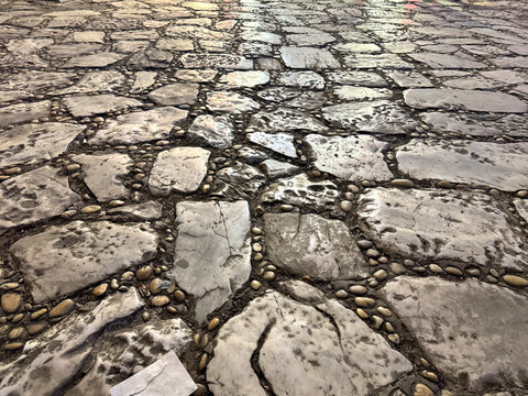 Natural random cut grey flagstone flattened on a surface. Or a series of cobble stones but flattened and paved seamlessly, for floor or wall finishes