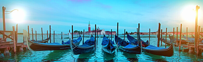 Mystical landscape with gondolas on the Grand Canal on the background of  Church of San Giorgio Maggiore at dawn in the light of lanterns and stars in Venice. banner © anko_ter