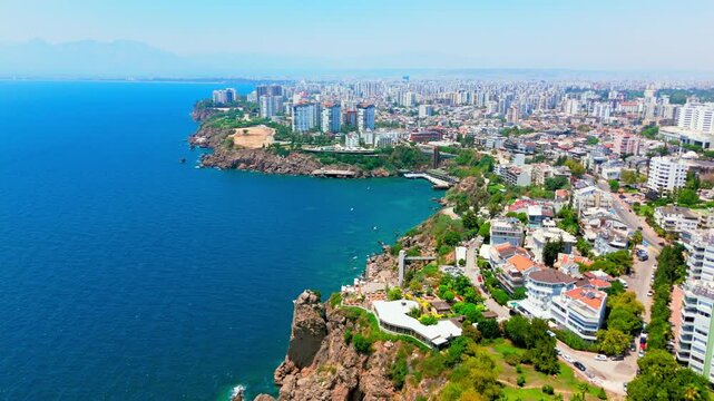 Clear view of a row of tall modern apartment towers dominating the skyline, near Lower Düden Waterfalls, Antalya, Turkey.