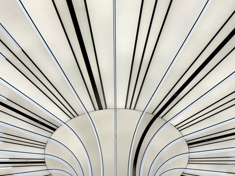Modern futuristic concept of illuminated panel with sunburst pattern in black and white color. Tilted black and white lines. Ceiling and wall design. Interior design, seamless background texture.