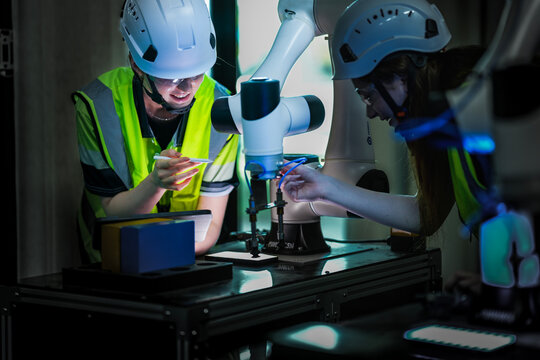 Focused AI researchers meticulousy calibrating an intelligent robotic prototype. Engineering team validating next-generation autonomous algorithms for innovative machine performance.