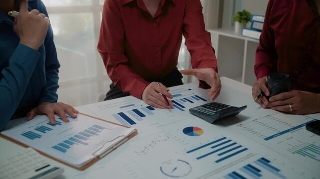 Business team analyzing financial data and charts during a corporate meeting in the office conference room