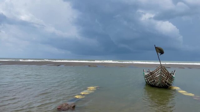 A picturesque view of Cox's Bazar's sandy beach and outrigger fishing boats in the sea. boat on the beach.