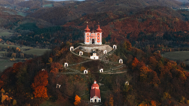 Aerial view of the Kalvaria Banska Stiavnica complex on a hill surrounded by autumn forests in Banska Stiavnica, Banskobystricky kraj, Slovakia.