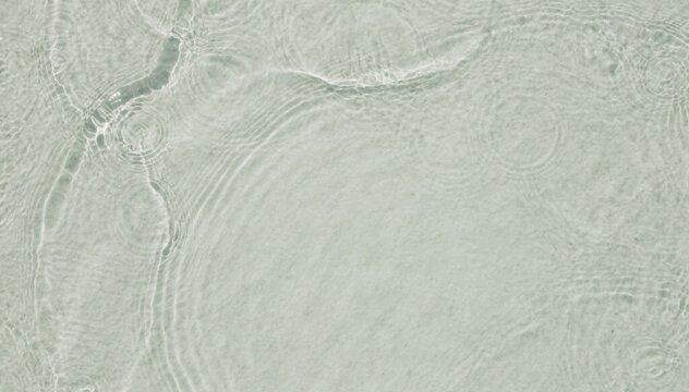 Pale sage green water surface with delicate ripples and soft shadow patterns for luxury beauty branding, wellness editorial backgrounds and organic product styling
