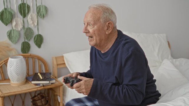 Man holding joystick, hands gripping game controller while sitting on bed in bedroom; playful nostalgia.
