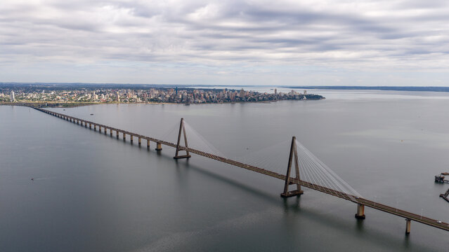 Side view of the Roque Gonzalez Bridge stretching across the Parana River on a cloudy day, Argentina and Paraguay.