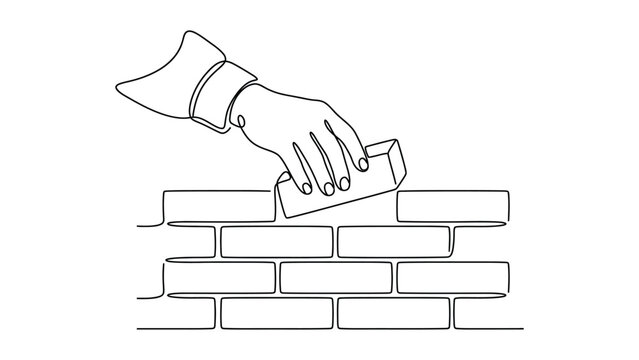 A hand building a brick wall.