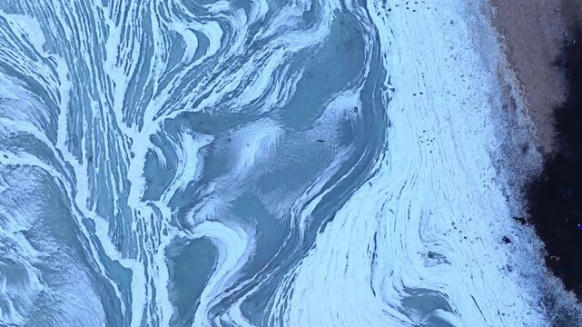 Winter Baltic coastline filmed from above, highlighting beautiful ice formations shaped by the sea.