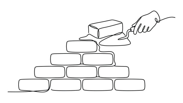 A hand building a brick wall.