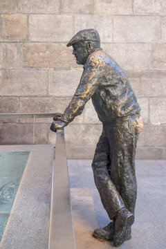 Madrid, Spain -April 15, 2026:The sculpture "Curious Neighbor" (El Vecino Curioso).The figure draws attention to the archaeological excavations of the old church of Almudena