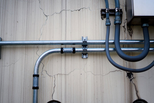 Electrical metal conduits on old wall