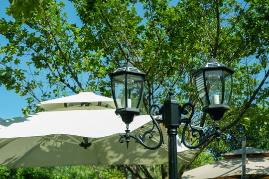 Lamp street in outdoor restaurant,Pendant light with matal lamps in street cafe,mountain view and sky,Simple home outdoor interior..