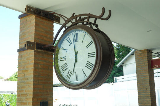 Retro Large decorative clock hanging from a train station,vintage old style,classic public clock in railway station subway central train station, watch time waiting train concept.