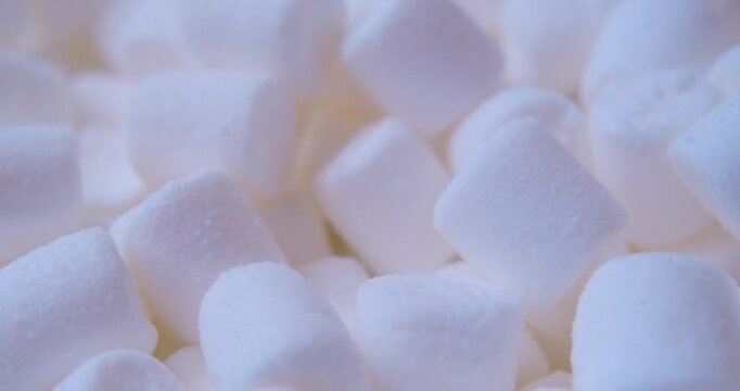 Close-up of many pieces of White Marshmallow. Sweet food. Macro with shallow depth of field.