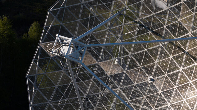 Aerial view of the Radiotelescoop showing its complex metal lattice structure and parabolic dish surrounded by lush green trees Dwingeloo, Drenthe, Netherlands.