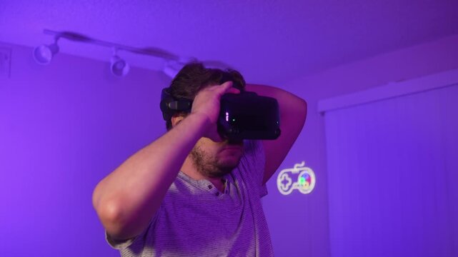 Man putting on virtual reality headset amazed exploring digital world immersing into modern virtual experience of entertainment technology and interactive environment