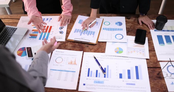 Business team working at office, using calculator to calculate company finance, accounting with laptop computer on table, budget management. Doing finance, budgeting and tax calculation